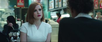 Movie still from “Miss Sloane” (2016), directed by John Madden – A woman in a white shirt is talking to a man; Close Up shot, Over the shoulder angle