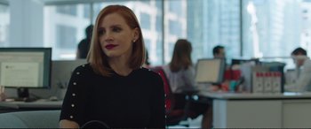 Movie still from “Miss Sloane” (2016), directed by John Madden – A person sitting in front of a laptop; Medium shot, Over the shoulder angle