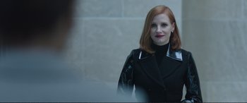 Movie still from “Miss Sloane” (2016), directed by John Madden – A woman with red hair wearing a black jacket; Close Up shot, Over the shoulder angle