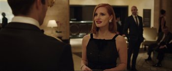 Movie still from “Miss Sloane” (2016), directed by John Madden – A woman in a black dress is standing in front of a mirror; Close Up shot, Over the shoulder angle
