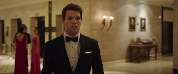 Movie still from “Miss Sloane” (2016), directed by John Madden – A man in a tuxedo standing in front of a mirror; Close Up shot, Over the shoulder angle