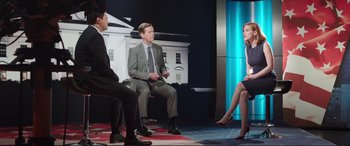 Movie still from “Miss Sloane” (2016), directed by John Madden – Three men and a woman sitting in a room; Wide shot, Over the shoulder angle