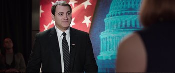 Movie still from “Miss Sloane” (2016), directed by John Madden – A person wearing a suit and tie; Medium shot, Over the shoulder angle