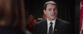 Movie still from “Miss Sloane” (2016), directed by John Madden – A person wearing a suit and tie; Close Up shot, Over the shoulder angle