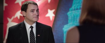 Movie still from “Miss Sloane” (2016), directed by John Madden – A person wearing a suit and tie; Close Up shot, High angle