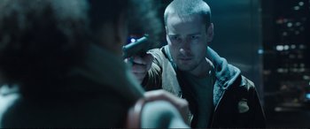 Movie still from “Miss Sloane” (2016), directed by John Madden – A man holding a gun in his hand while looking at another man; Close Up shot, Over the shoulder angle