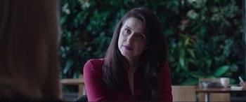 Movie still from “Miss Sloane” (2016), directed by John Madden – A woman in a red shirt sitting in front of a tree; Close Up shot, Over the shoulder angle