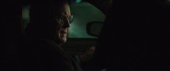 Movie still from “Miss Sloane” (2016), directed by John Madden – An older man driving a car at night; Close Up shot, Over the shoulder angle