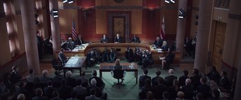 Movie still from “Miss Sloane” (2016), directed by John Madden – A group of people sitting around a conference room; Wide shot, High angle