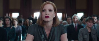 Movie still from “Miss Sloane” (2016), directed by John Madden – A person sitting at a table; Close Up shot, Low angle