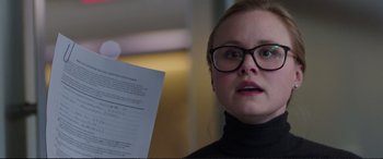 Movie still from “Miss Sloane” (2016), directed by John Madden – A woman in glasses holding up a piece of paper; Close Up shot, Over the shoulder angle