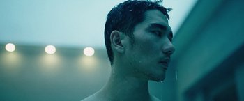 Movie still from “Night in Paradise” (2020), directed by Park Hoon-jung – A person with a wet shirt on; Close Up shot, Low angle