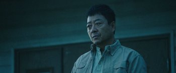 Movie still from “Night in Paradise” (2020), directed by Park Hoon-jung – A person wearing a jacket; Close Up shot, Low angle