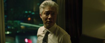 Movie still from “Night in Paradise” (2020), directed by Park Hoon-jung – A person wearing a shirt and a tie; Close Up shot, Low angle