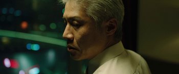 Movie still from “Night in Paradise” (2020), directed by Park Hoon-jung – A person wearing a white shirt; Close Up shot, Low angle