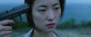 Movie still from “Night in Paradise” (2020), directed by Park Hoon-jung – A person's face with headphones on; Close Up shot, High angle