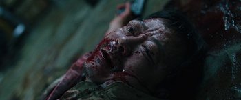 Movie still from “Night in Paradise” (2020), directed by Park Hoon-jung – A man with blood all over his face and head; Close Up shot, High angle