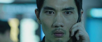 Movie still from “Night in Paradise” (2020), directed by Park Hoon-jung – A man's face in a dark room; Close Up shot, High angle