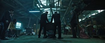 Movie still from “Night in Paradise” (2020), directed by Park Hoon-jung – A group of men standing next to each other in a building; Wide shot, Low angle