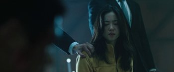 Movie still from “Night in Paradise” (2020), directed by Park Hoon-jung – A man holding a woman's hand over her shoulder; Close Up shot, Over the shoulder angle