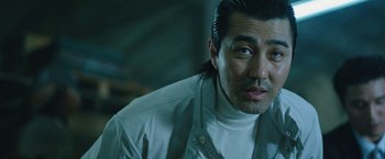 Movie still from “Night in Paradise” (2020), directed by Park Hoon-jung – A person with long black hair; Close Up shot, Over the shoulder angle