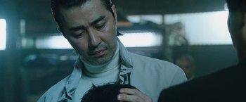 Movie still from “Night in Paradise” (2020), directed by Park Hoon-jung – A person holding a baby; Close Up shot, Over the shoulder angle