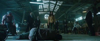 Movie still from “Night in Paradise” (2020), directed by Park Hoon-jung – A group of men standing in a warehouse; Wide shot, Low angle