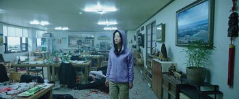 Movie still from “Night in Paradise” (2020), directed by Park Hoon-jung – A woman standing in a room with blood on the floor; Wide shot, High angle