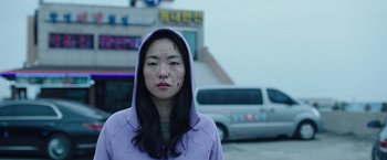 Movie still from “Night in Paradise” (2020), directed by Park Hoon-jung – A young woman with blood all over her face; Close Up shot, Low angle