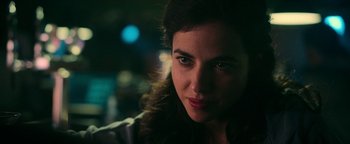 Movie still from “No One Gets Out Alive” (2021), directed by Santiago Menghini – A woman's face in the dark; Close Up shot, Over the shoulder angle