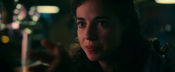 Movie still from “No One Gets Out Alive” (2021), directed by Santiago Menghini – A woman's face in the dark; Close Up shot, Over the shoulder angle