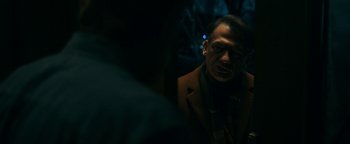 Movie still from “No One Gets Out Alive” (2021), directed by Santiago Menghini – A man in a brown jacket is looking into a mirror; Close Up shot, Over the shoulder angle