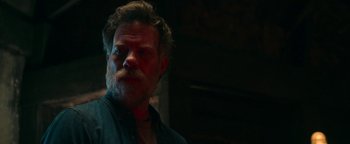 Movie still from “No One Gets Out Alive” (2021), directed by Santiago Menghini – A person with a beard; Close Up shot, Over the shoulder angle