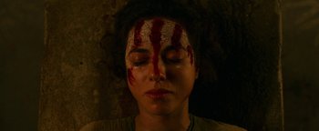 Movie still from “No One Gets Out Alive” (2021), directed by Santiago Menghini – A woman with blood all over her face; Close Up shot, Overhead angle