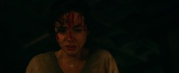 Movie still from “No One Gets Out Alive” (2021), directed by Santiago Menghini – A woman with blood all over her face; Close Up shot, High angle