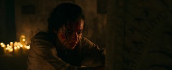 Movie still from “No One Gets Out Alive” (2021), directed by Santiago Menghini – A woman with blood all over her face; Close Up shot, High angle