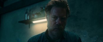 Movie still from “No One Gets Out Alive” (2021), directed by Santiago Menghini – A person with a beard; Close Up shot, Low angle