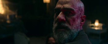 Movie still from “No One Gets Out Alive” (2021), directed by Santiago Menghini – A person with a beard; Close Up shot, Over the shoulder angle