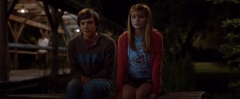 Movie still from “No Strings Attached” (2011), directed by Ivan Reitman – A young man and a young woman sitting next to each other; Medium shot, Over the shoulder angle