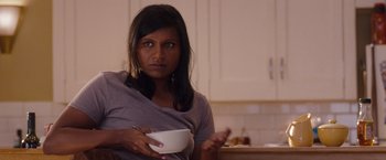 Movie still from “No Strings Attached” (2011), directed by Ivan Reitman – A woman holding a white bowl in a kitchen; Medium shot, Over the shoulder angle