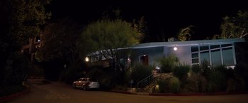 Movie still from “No Strings Attached” (2011), directed by Ivan Reitman – A car parked in front of a building at night; Extreme Wide shot, Low angle