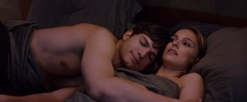 Movie still from “No Strings Attached” (2011), directed by Ivan Reitman – A man and a woman laying in bed together; Medium shot, Overhead angle