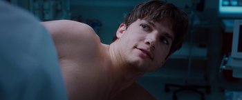 Movie still from “No Strings Attached” (2011), directed by Ivan Reitman – A man's chest and shoulders; Close Up shot, Low angle