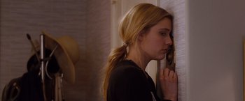 Movie still from “No Strings Attached” (2011), directed by Ivan Reitman – A woman leaning against a wall with her hand to her face; Close Up shot, Over the shoulder angle