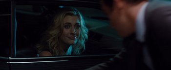 Movie still from “No Strings Attached” (2011), directed by Ivan Reitman – A woman sitting in the back seat of a car looking into a mirror; Close Up shot, Over the shoulder angle