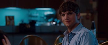 Movie still from “No Strings Attached” (2011), directed by Ivan Reitman – A man sitting in front of a camera in a room; Close Up shot, Over the shoulder angle