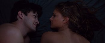 Movie still from “No Strings Attached” (2011), directed by Ivan Reitman – A man and a woman laying in bed together; Close Up shot, Overhead angle