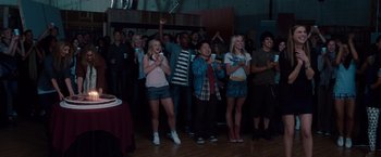 Movie still from “No Strings Attached” (2011), directed by Ivan Reitman – A group of people standing in front of a cake; Wide shot, High angle
