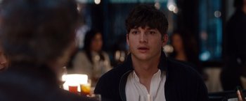 Movie still from “No Strings Attached” (2011), directed by Ivan Reitman – A man sitting at a table in front of candles; Close Up shot, Over the shoulder angle