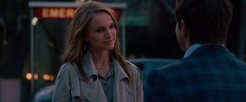 Movie still from “No Strings Attached” (2011), directed by Ivan Reitman – A woman with long brown hair standing in a street; Close Up shot, Over the shoulder angle